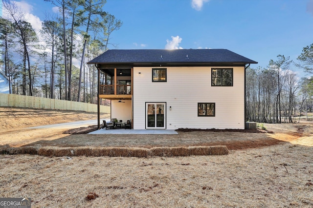 rear view of house with a patio, fence, and a balcony