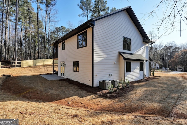 view of property exterior featuring fence and central air condition unit