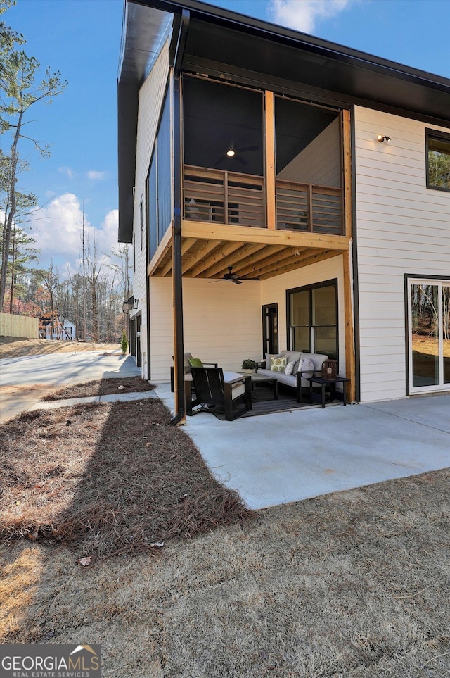 rear view of house with a patio, a balcony, and an outdoor hangout area