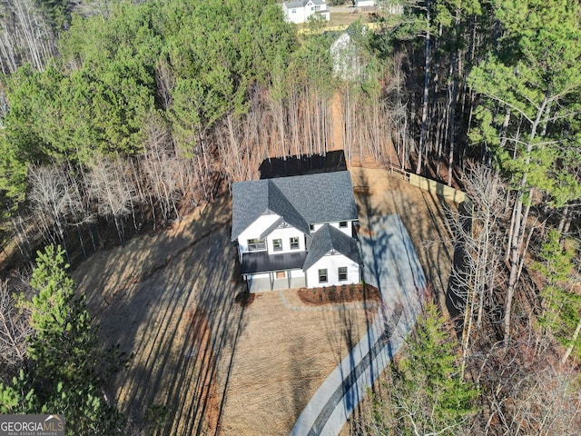 drone / aerial view featuring a view of trees