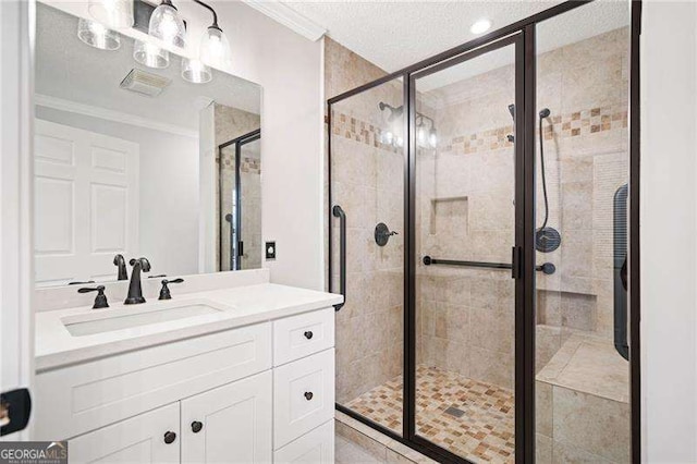 bathroom featuring a stall shower, ornamental molding, and vanity