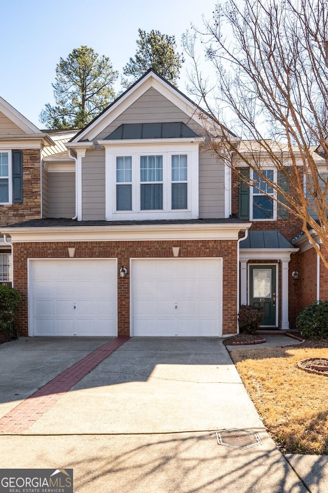 multi unit property with concrete driveway, brick siding, and an attached garage