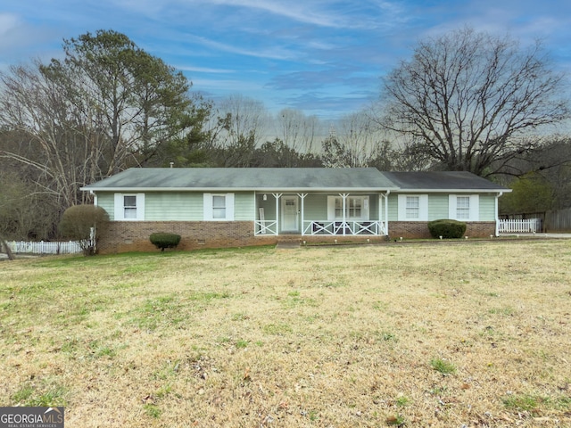 ranch-style house with a porch, a front lawn, and fence