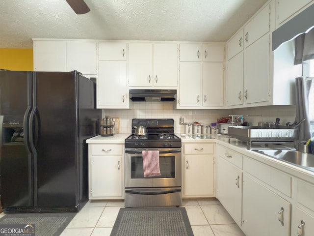 kitchen with stainless steel gas range oven, decorative backsplash, black fridge with ice dispenser, and under cabinet range hood