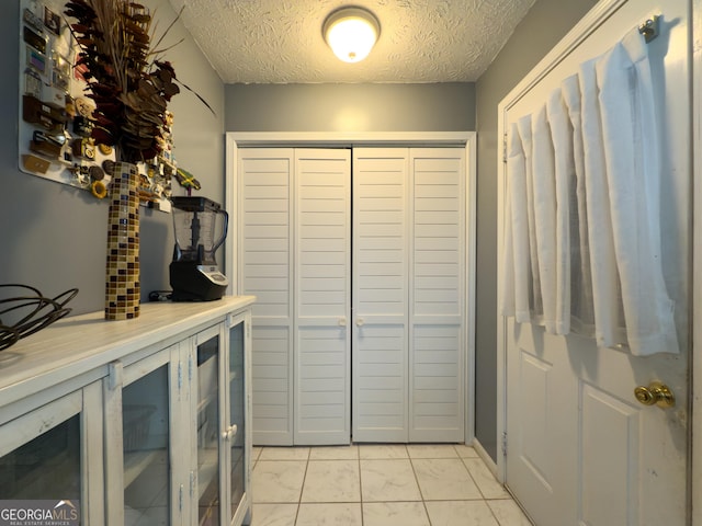 interior space featuring a textured ceiling