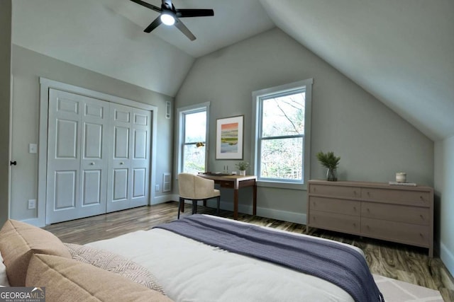 bedroom featuring lofted ceiling, light wood-style floors, and baseboards