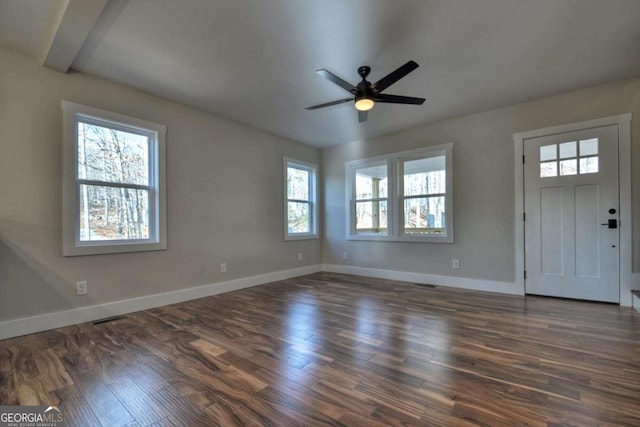 interior space with a ceiling fan, dark wood finished floors, and baseboards