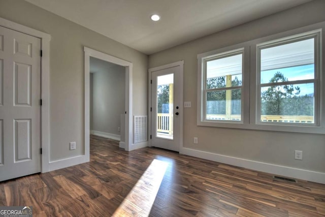 entryway with recessed lighting, visible vents, dark wood finished floors, and baseboards