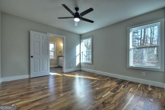 unfurnished bedroom featuring a ceiling fan, baseboards, and dark wood-style flooring