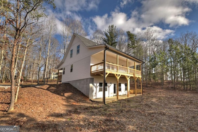 rear view of house featuring a deck