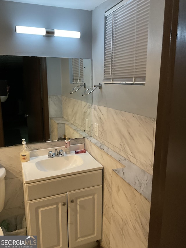3630 High Point Ln SW, Atlanta, GA 30331 - bathroom featuring tile walls, toilet, vanity, and a wainscoted wall