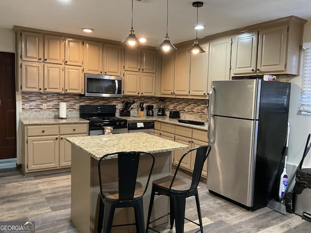 3630 High Point Ln SW, Atlanta, GA 30331 - kitchen featuring appliances with stainless steel finishes, light wood-style flooring, tasteful backsplash, a kitchen island, and recessed lighting