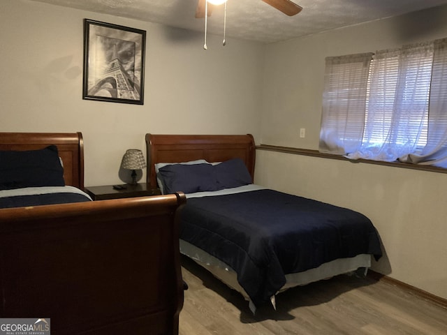 bedroom featuring ceiling fan and wood finished floors