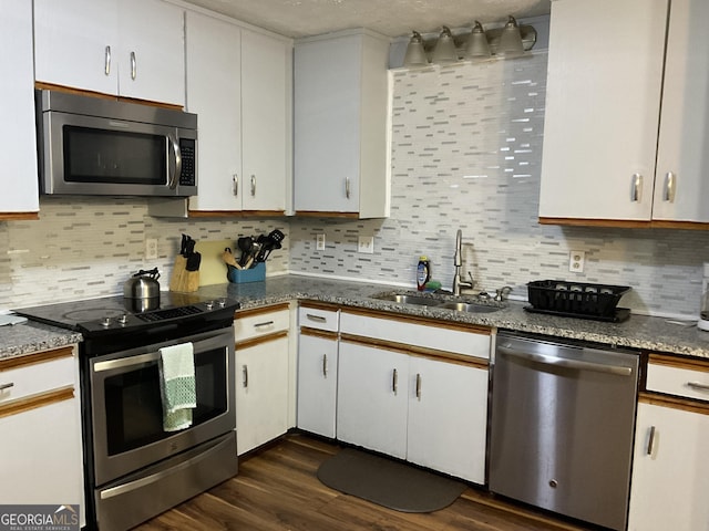3630 High Point Ln SW, Atlanta, GA 30331 - kitchen featuring appliances with stainless steel finishes, a sink, decorative backsplash, dark wood-style flooring, and white cabinets