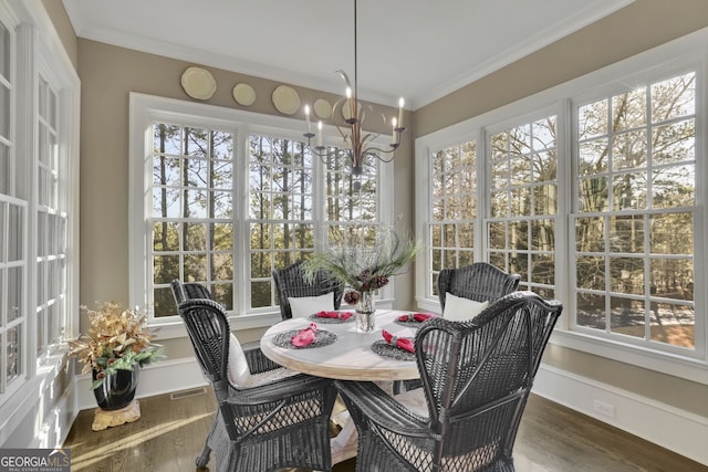 sunroom / solarium featuring visible vents and a notable chandelier