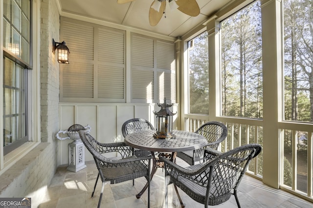 sunroom / solarium featuring a wealth of natural light and ceiling fan