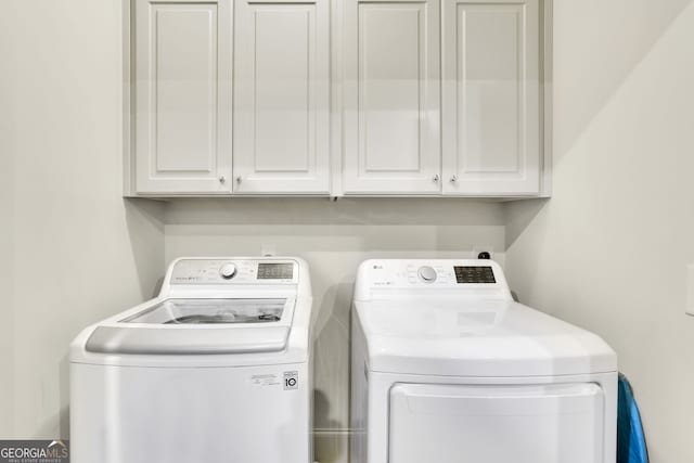 laundry room featuring cabinet space and washer and clothes dryer