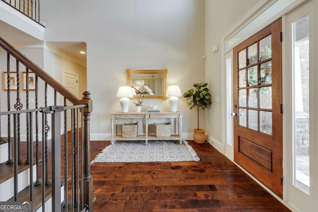 foyer with dark wood-style floors, baseboards, and a healthy amount of sunlight