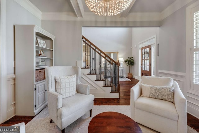 interior space with wood finished floors, a notable chandelier, stairs, crown molding, and beam ceiling