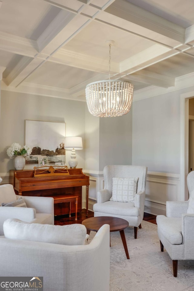 interior space featuring coffered ceiling, wood finished floors, beam ceiling, an inviting chandelier, and crown molding