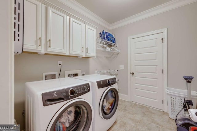 laundry room featuring cabinet space, washer and clothes dryer, and crown molding