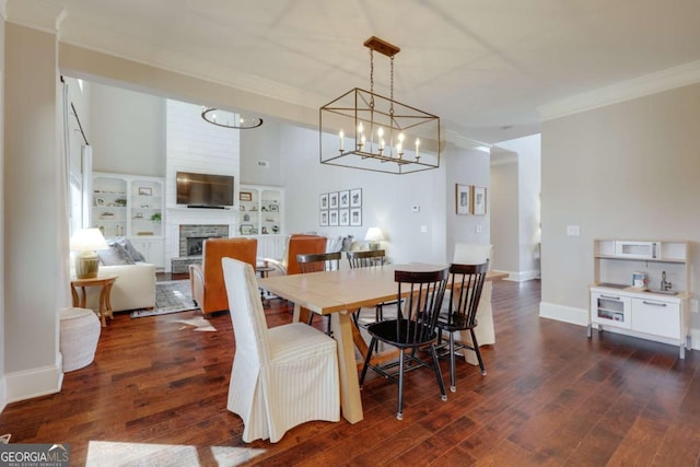 dining room with baseboards, a stone fireplace, dark wood-type flooring, and crown molding