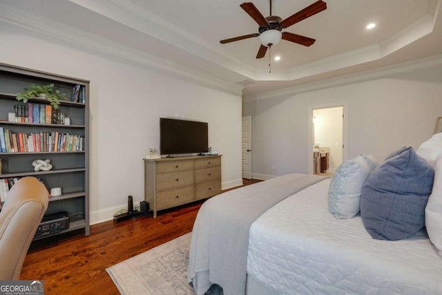 bedroom featuring dark wood-style floors, crown molding, recessed lighting, a raised ceiling, and baseboards