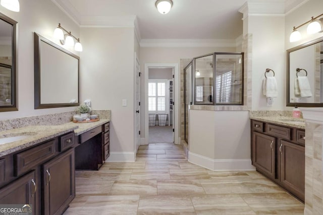 bathroom featuring two vanities, a sink, baseboards, a stall shower, and crown molding