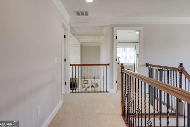 corridor with ornamental molding, carpet, visible vents, and an upstairs landing