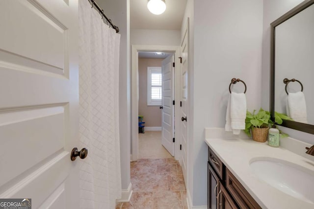 bathroom featuring vanity and baseboards