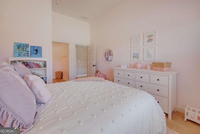 bedroom featuring high vaulted ceiling, light carpet, and baseboards