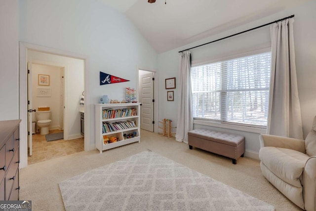 living area featuring ceiling fan, baseboards, vaulted ceiling, and light colored carpet