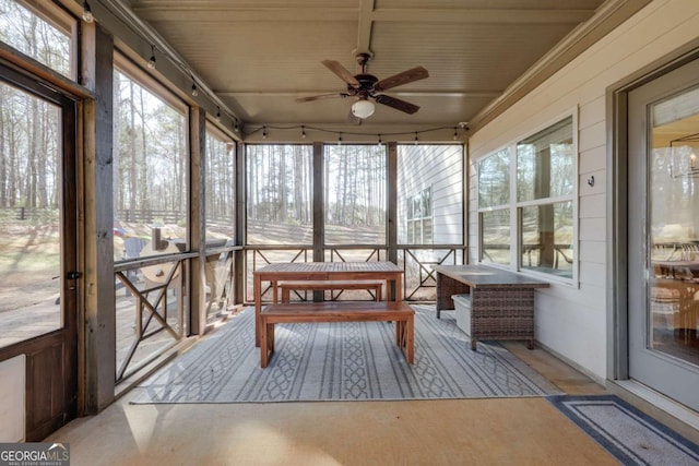 sunroom / solarium featuring a healthy amount of sunlight and ceiling fan