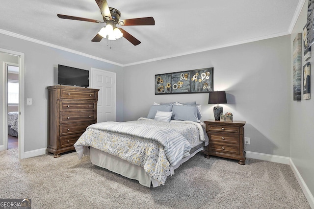 carpeted bedroom featuring ceiling fan, ornamental molding, and baseboards