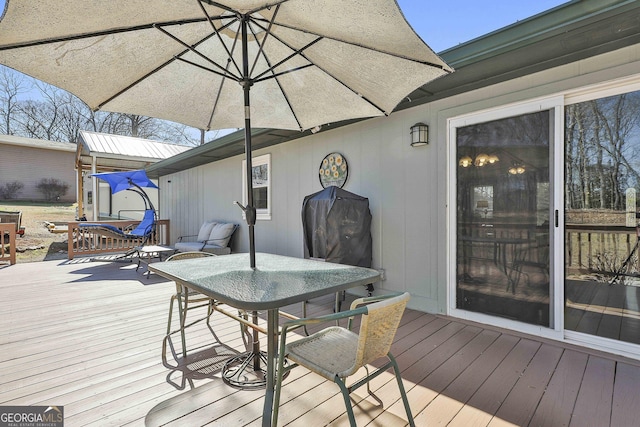 wooden terrace featuring outdoor dining space