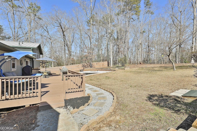 view of yard featuring outdoor dining area and a wooden deck