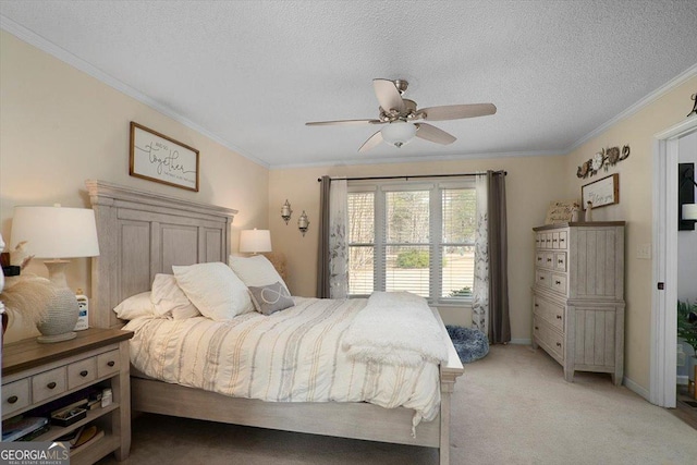 bedroom with ceiling fan, light colored carpet, a textured ceiling, and crown molding