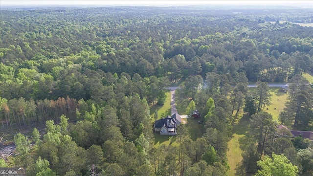 birds eye view of property with a forest view