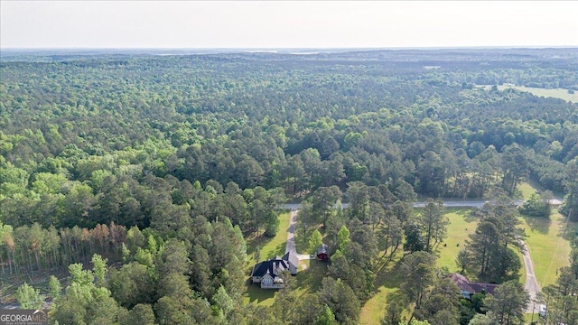 birds eye view of property with a view of trees