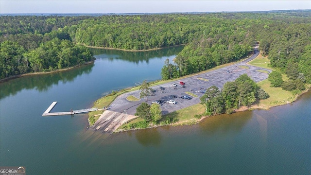 aerial view featuring a water view and a forest view