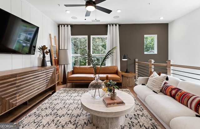 living area with wood finished floors, ceiling fan, and recessed lighting