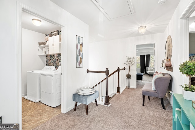 living area with light carpet, washing machine and dryer, attic access, and baseboards