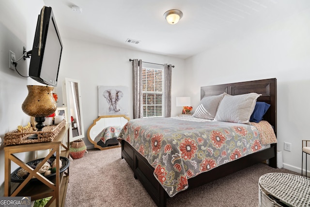 carpeted bedroom featuring visible vents and baseboards