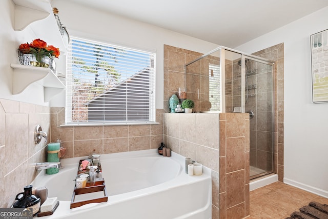 bathroom with tile patterned flooring, a shower stall, and a bath