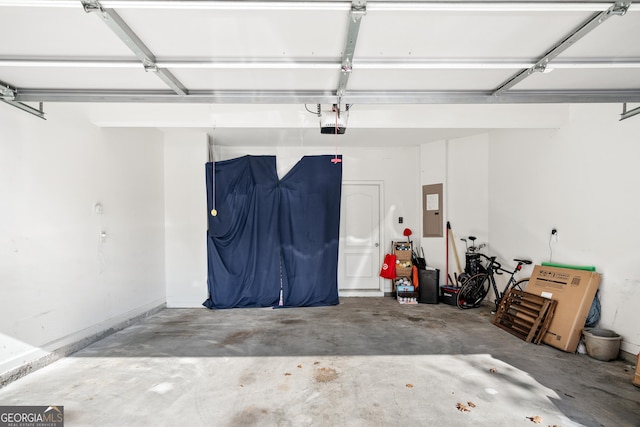 garage with a garage door opener and electric panel