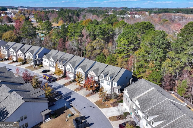 birds eye view of property with a residential view and a view of trees