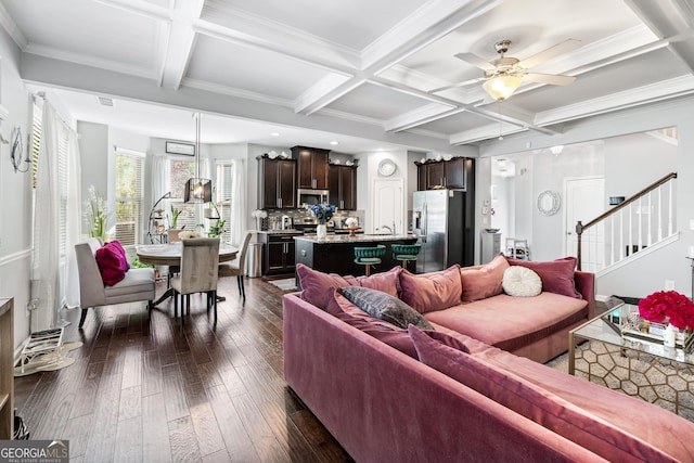 living area featuring dark wood-style floors, stairway, coffered ceiling, and beam ceiling