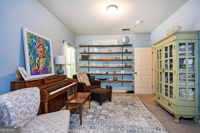 sitting room featuring carpet floors and visible vents