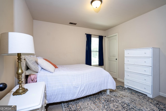 carpeted bedroom featuring baseboards and visible vents