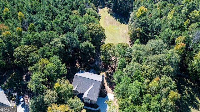 birds eye view of property featuring a view of trees